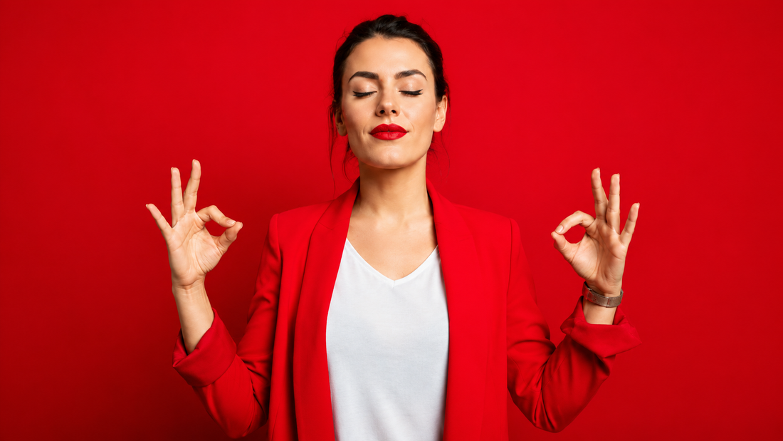 Woman meditating against red background with calm and relaxed expression
