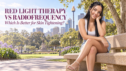Woman sitting in Sydney's Hyde Park with Sydney Tower Eye in the background, featured in Beauty by Light's red light therapy vs radiofrequency skin tightening guide.