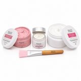 Beauty products including jars and a brush on a white background